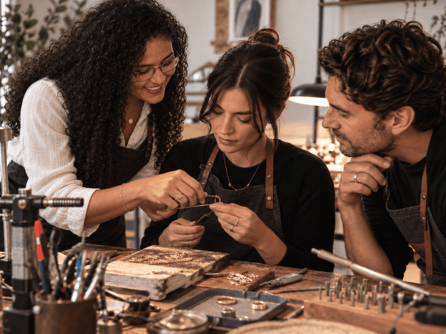 Two people sharing a jewelry-making workshop experience.